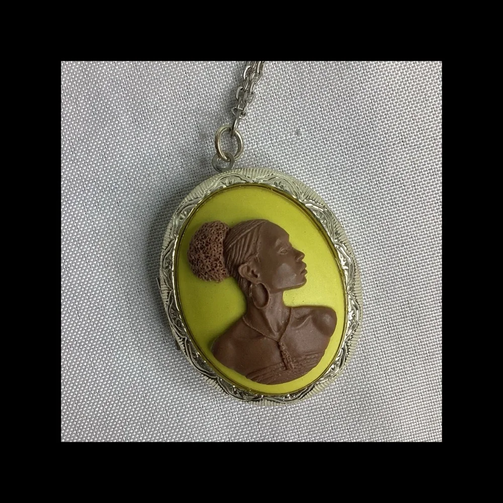 Multicolor raised cameo locket.